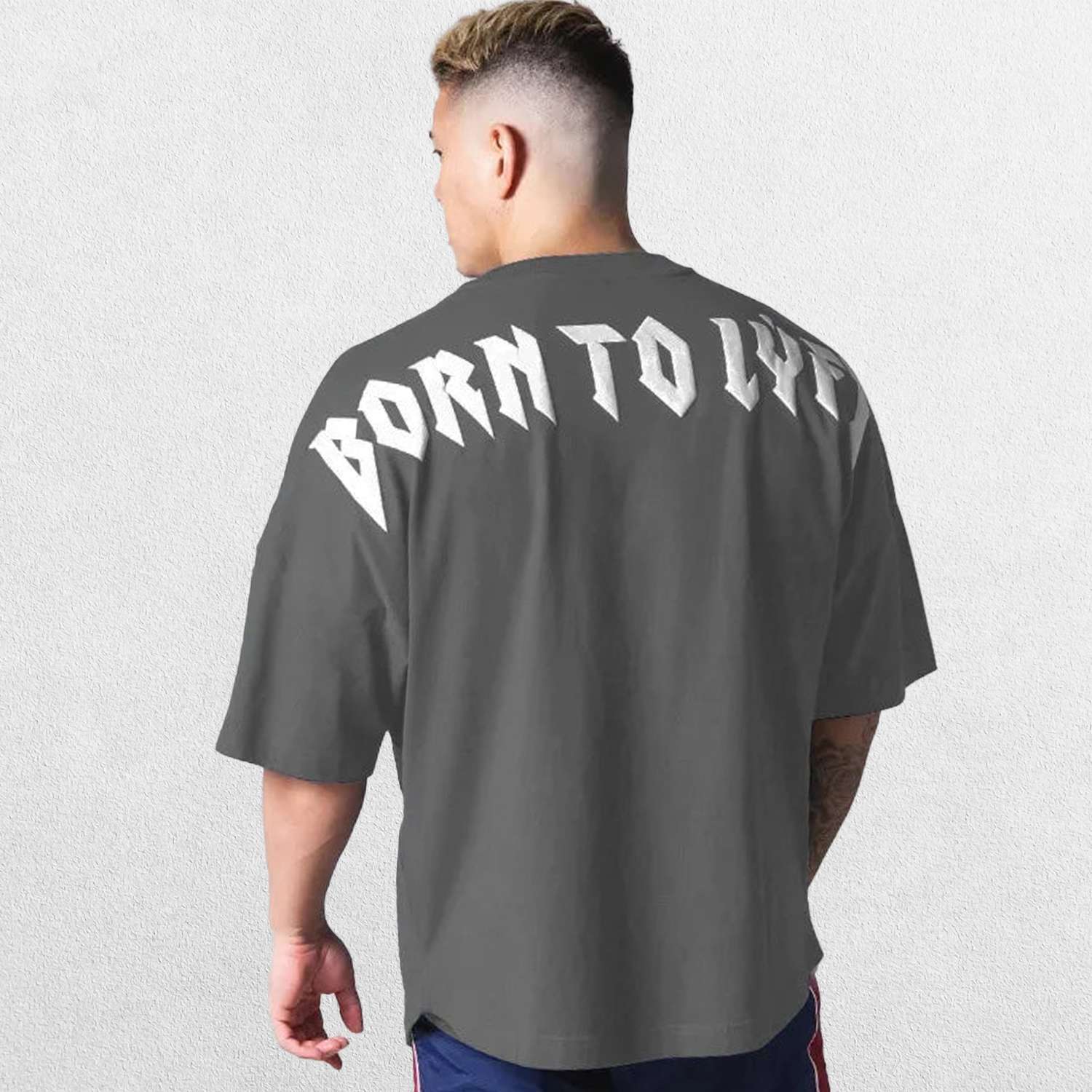 Model wearing Dark Grey GPW Oversized T-Shirt, styled for streetwear and gy