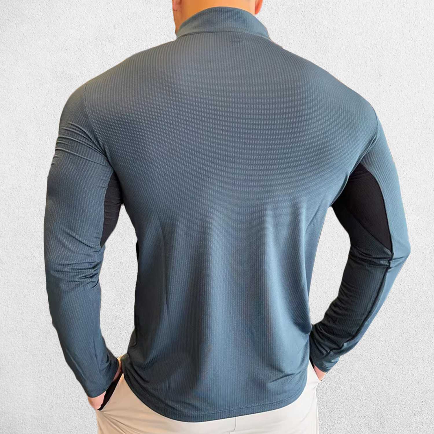 Back Pose of Model wearing Dark Grey Men's Activewear Sweat-Wicking High Collar Compression Top with Long Sleeves