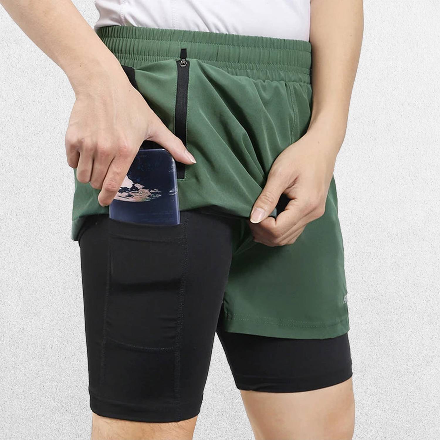 Close-up of Forest Green Men’s Breathable 2-in-1 Gym Shorts with Zipper Pockets & Drawstring Fit in a studio background