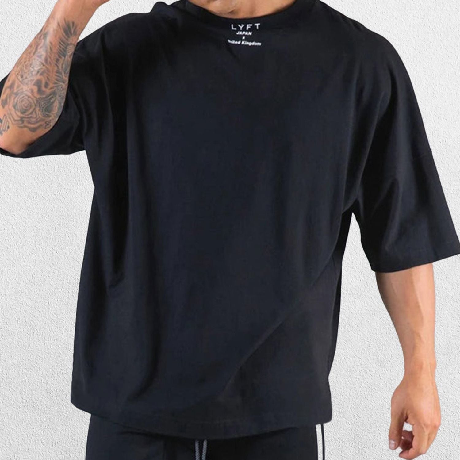 Close-up of premium cotton fabric in a BLack loose-fit gym shirt.