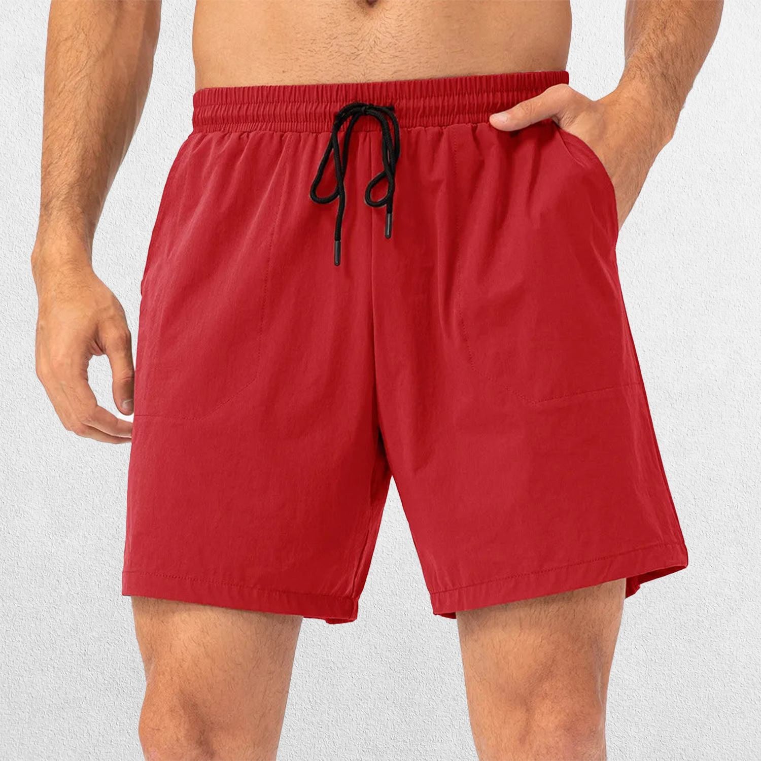 Model in fire brick red GPW Men's Performance Shorts with hand in pocket