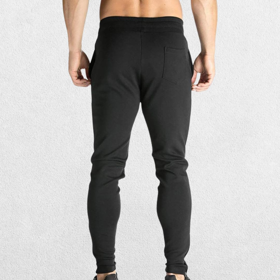 GPW Men’s Slim Fit Zip Athletic Pants Black Back View in Studio Background