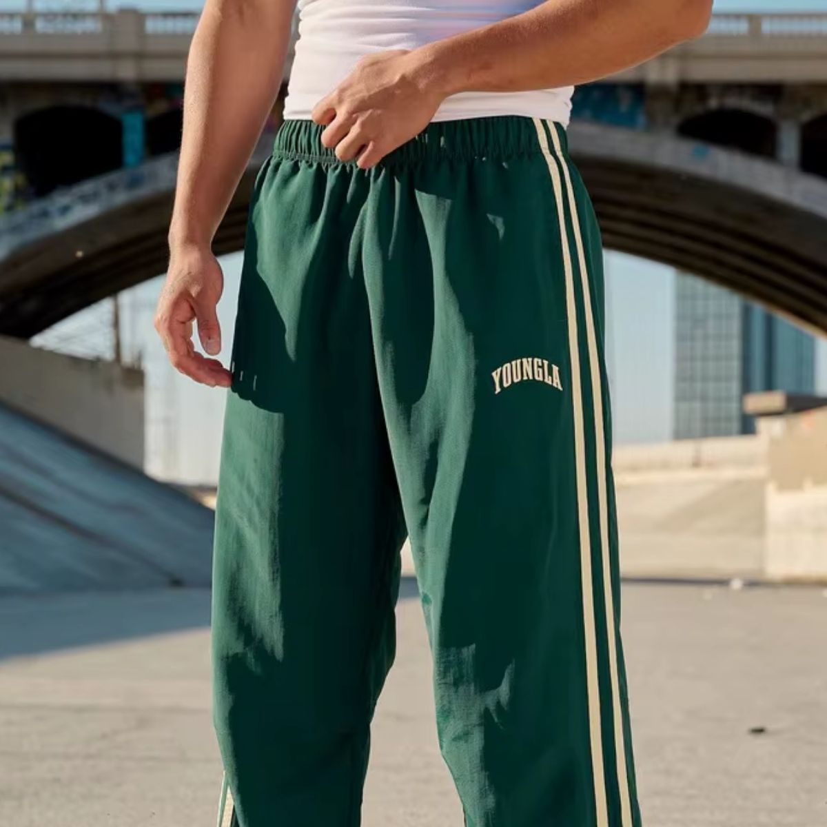 Model showcasing the fit and style of green GPW Men’s Sports Pants during a workout.
