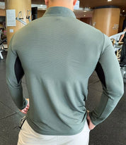 Back Pose of Model wearing Light Green Men's Activewear Sweat-Wicking High Collar Compression Top in gym background