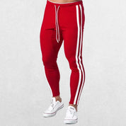 Front view of Men’s Striped Joggers in red, featuring an adjustable drawstring waistband and sporty stripe design.