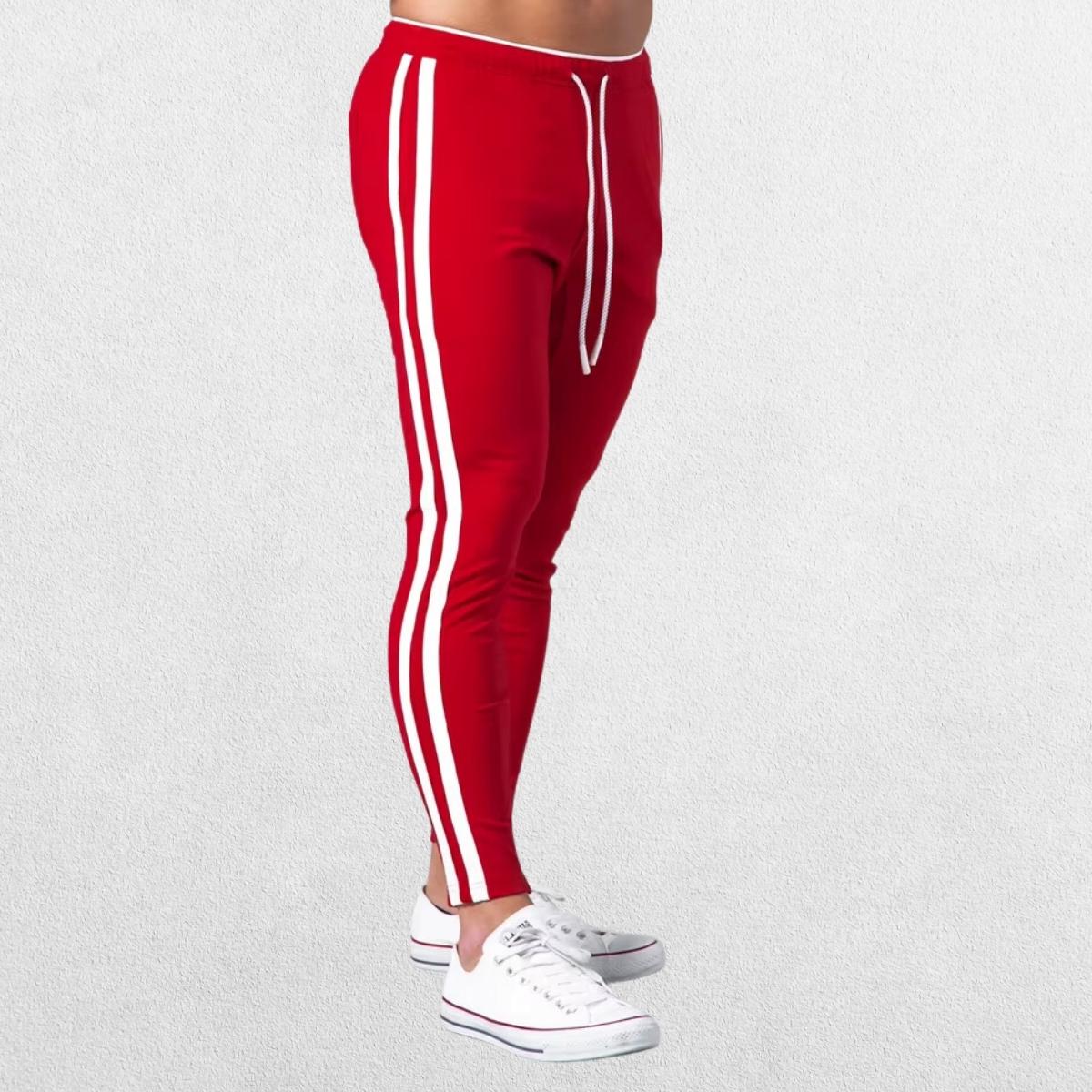 Side view of red Men’s Striped Joggers highlighting the bold stripe detail and slim-fit style.