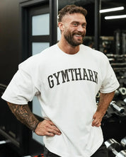 Side View of Model Wearing White Loose Fit Oversized Gym Tee – Heavyweight Cotton, Premium Comfort & Strength in a gym