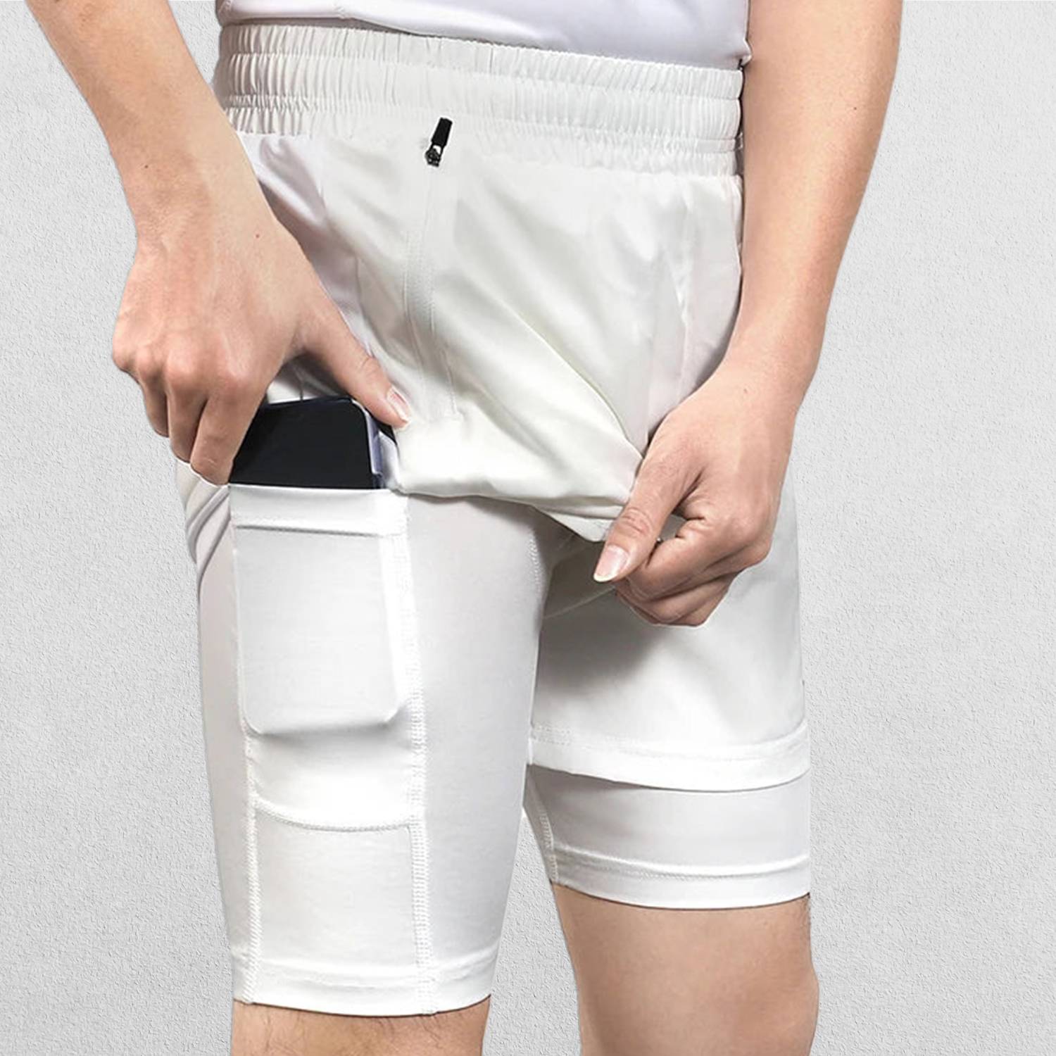 Close-up of White Men’s Breathable 2-in-1 Gym Shorts with Zipper Pockets & Drawstring Fitin a studio background